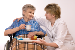 Staff serving food to Elder Woman