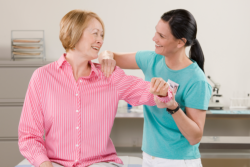 Caregiver giving massage to the Elder Woman